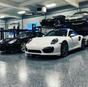 Luxury sports cars parked on a polished epoxy garage floor coating